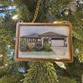 Decorative ornament of a house on a Christmas tree